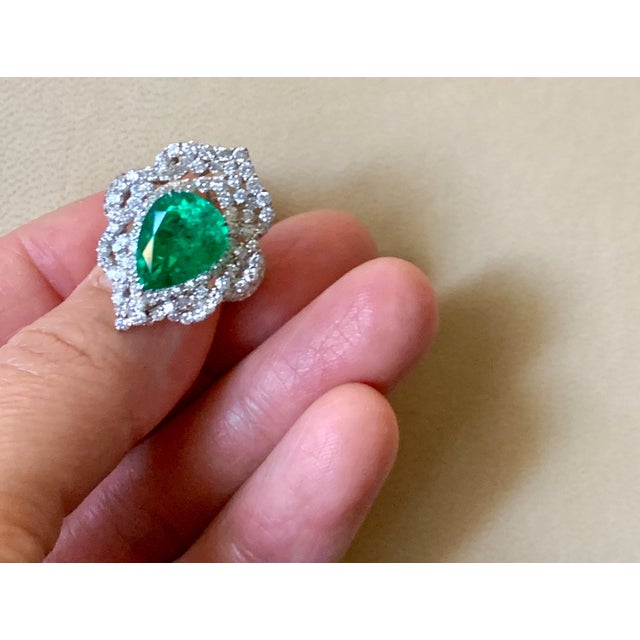 This classic Cocktail ring is a true masterpiece, featuring a breathtaking 4.75 Carat Colombian Emerald that is set in 18...