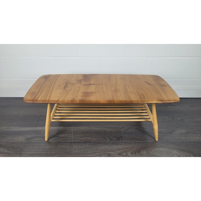 Vintage Ercol Model 459 coffee table dating from the 1970s, featuring a beautifully figured solid English elm top, tapered...