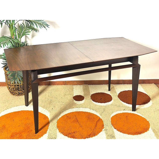 A timeless classic of mid-century design, this 1960s teak table combines style, functionality, and quality craftsmanship....
