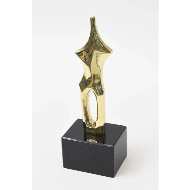 This small fabulous vintage signed polished bronze sculpture of a female form in some abstraction. It sits on a black...
