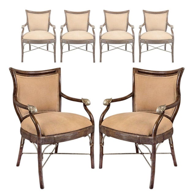 A substantial set of four dining armchairs featuring faux bamboo hardwood frames and distinctive gilt scroll-form arm...
