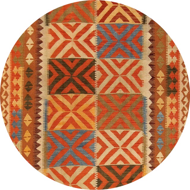 A hand-knotted Kilim rug with a geometric design. This piece has great detailing and beautiful colors. It would be the...