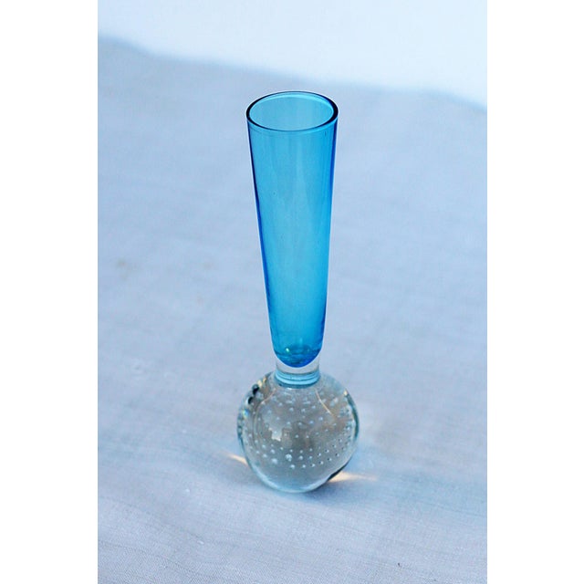 This vintage Murano-style art glass bud vase features a striking clear glass spherical base crafted using the...