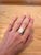 An opal takes centre stage in a shifting play of colour at the centre of this solid 14K yellow gold ring. No two opals are...