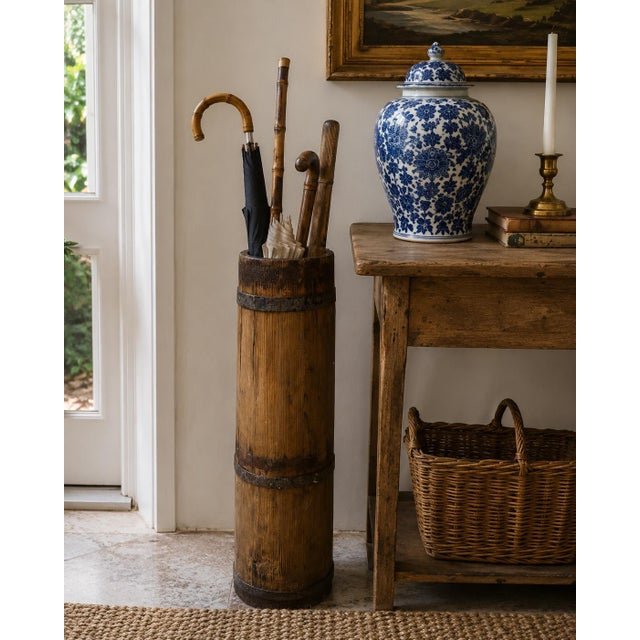 A charming late 19th century wood and iron tall bucket or umbrella stand with a warm, timeworn surface and beautifully...