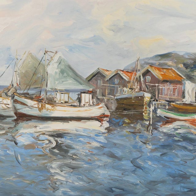 A beautifully executed Scandinavian coastal harbor scene depicting fishing boats resting alongside weathered waterfront...