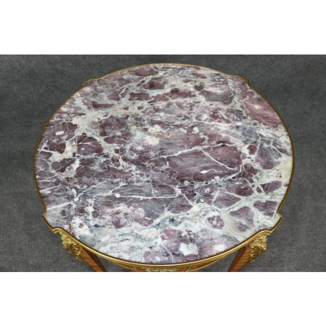 This is a breathtaking center table with a fantastic inset lavender and white marble top and superb Dore' bronze mounts...