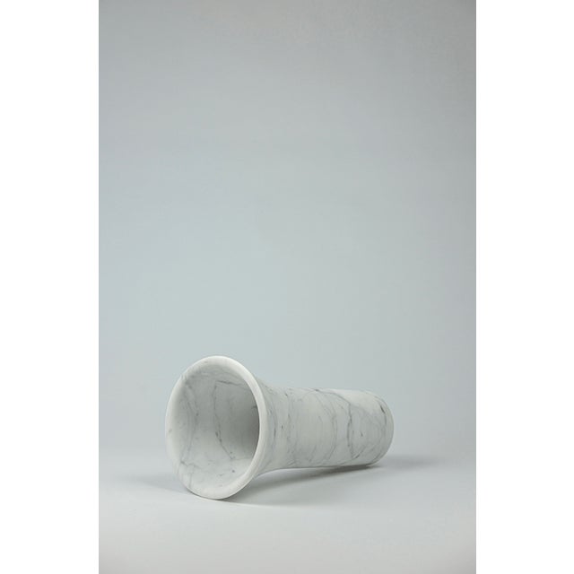 Three cylindrical music boxes gradually open upward, like resonant cavities carved in marble, transforming the gesture of...