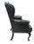 This is a classic, high-back wingback armchair upholstered in black leather. The backrest features deep button tufting in...
