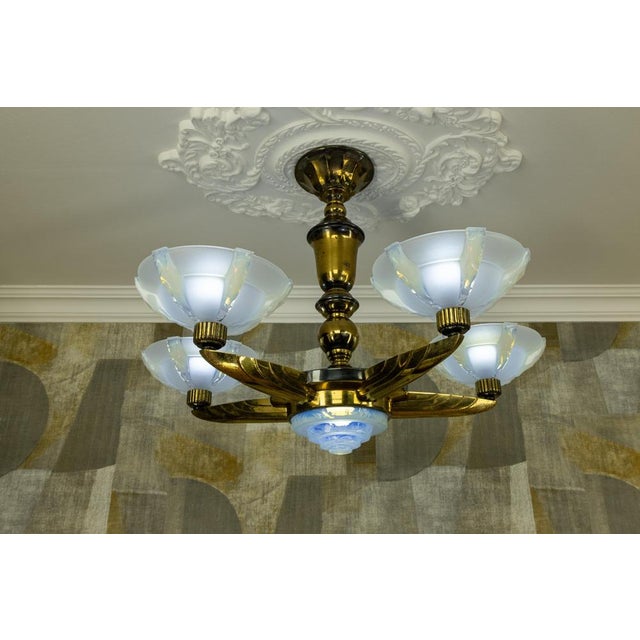 French Art Deco chandelier with opalescent glass shades, circa 1930s (attributed to Ezan). Elegant chandelier featuring a...