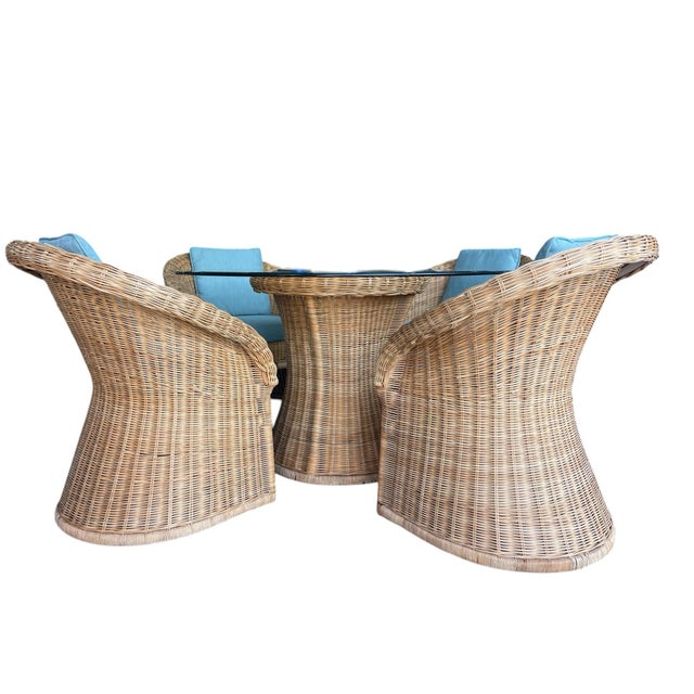 Vintage wicker dining set featuring sculptural pedestal base table and four matching barrel armchairs. Classic organic...
