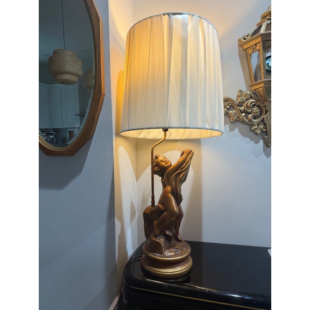 Bring timeless elegance and sculptural beauty to your space with this striking vintage figural table lamp featuring a...
