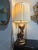 Bring timeless elegance and sculptural beauty to your space with this striking vintage figural table lamp featuring a...