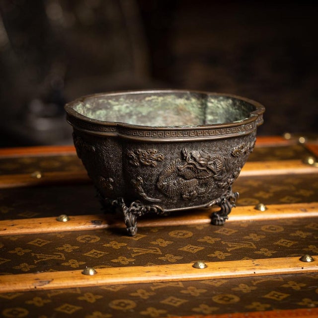 Antique 19th Century Japanese bronze vessel, Edo period. Of lobed form, raised on four feet shaped as waves, the body...