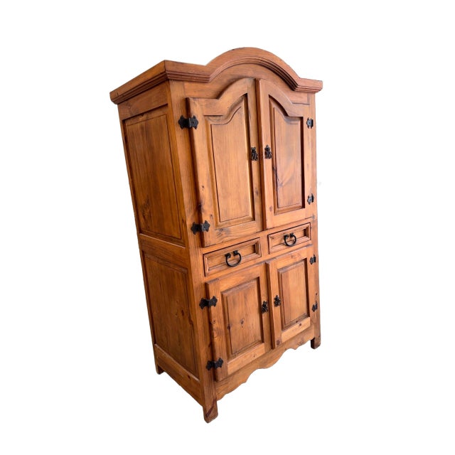 A charming 1980s rustic pine armoire that showcases timeless craftsmanship and natural warmth. Constructed from solid...