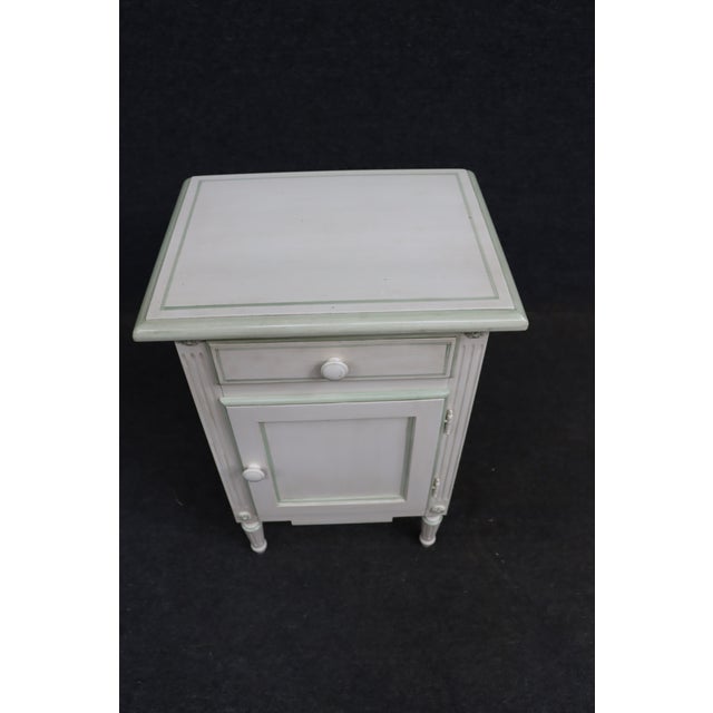 Charming Louis XVI-style nightstand featuring a single drawer over a paneled cabinet door, raised molded top, fluted...