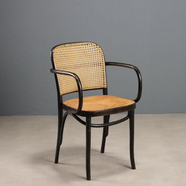 Vintage Thonet-style chair with stained beech wood frame, seat and backrest in Vienna straw. This piece is attributed to...