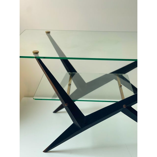 Elegant coffee table produced by maison jarden – france, circa 1950. its black steel base – compass-shaped – punctuated...
