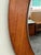Beautiful mid-century modern round wall mirror crafted in Denmark, featuring a solid teak frame with warm, even grain and...