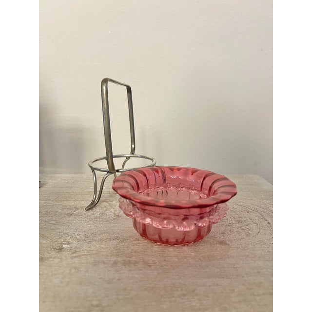 Antique cranberry Art glass bowl set in an metal silver holder. Features a vibrant pink or "cranberry" colored glass bowl...