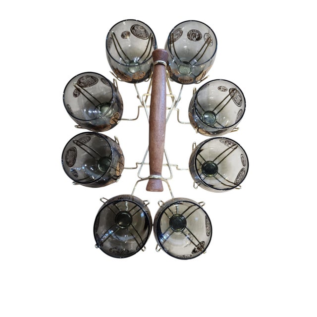 Excellent condition set of Libbey Glass Co. roly poly glasses in Roman motif with teak handled carrier. 22kt gilding to...