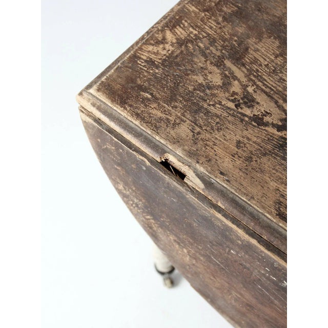 This antique drop leaf table combines vintage charm with practicality and convenience - perfect for smaller spaces. The...