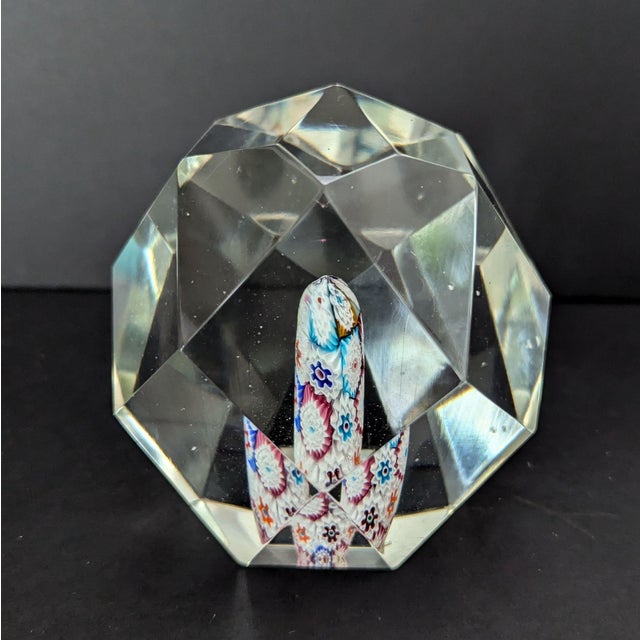 This is an Art Glass Paperweight with a Millefiori Flower Core and Gem Cut Faceted exterior styled after Murano glass...