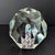 This is an Art Glass Paperweight with a Millefiori Flower Core and Gem Cut Faceted exterior styled after Murano glass...