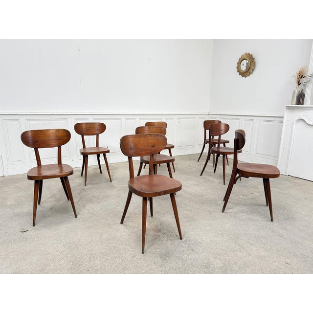 Made of beech wood, these vintage chairs have retained a beautiful original patina with dark brown hues tending towards...