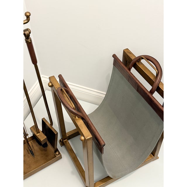 A complete Pottery Barn Industrial fireplace set, featuring a 4-piece iron and zinc fireplace tool collection with leather...