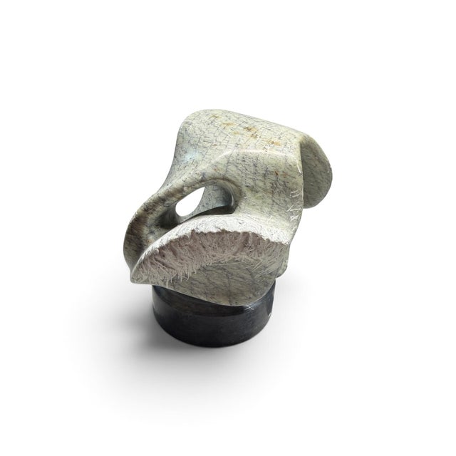 Striking abstract stone sculpture by artist Alain Prévost, dating to 1982. This sculptural work features a fluid,...