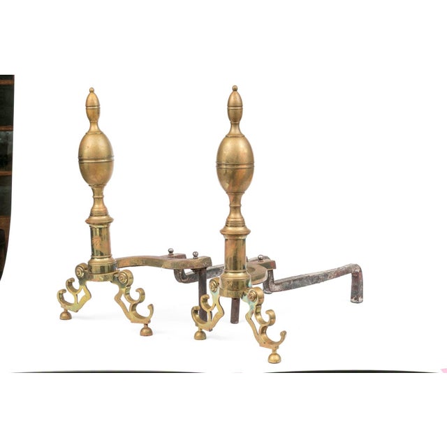 A large pair of 19th century neoclassical style andirons with beaded bands around double lemon finials, turned shafts,...