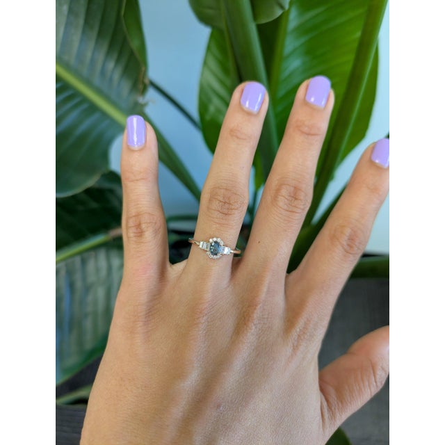 A natural colour-change alexandrite glows at the centre of this solid 14K rose gold ring, framed by fourteen earth-mined...
