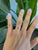 A natural colour-change alexandrite glows at the centre of this solid 14K rose gold ring, framed by fourteen earth-mined...