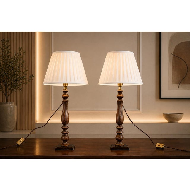 A beautiful pair of vintage turned wood table lamps (set of 2), finished in a rich dark tone with warm, time-earned...