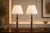 A beautiful pair of vintage turned wood table lamps (set of 2), finished in a rich dark tone with warm, time-earned...