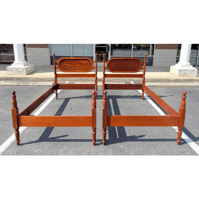 This vintage pair of mahogany twin bed frames features a warm, richly toned finish with classic turned posts and oval...