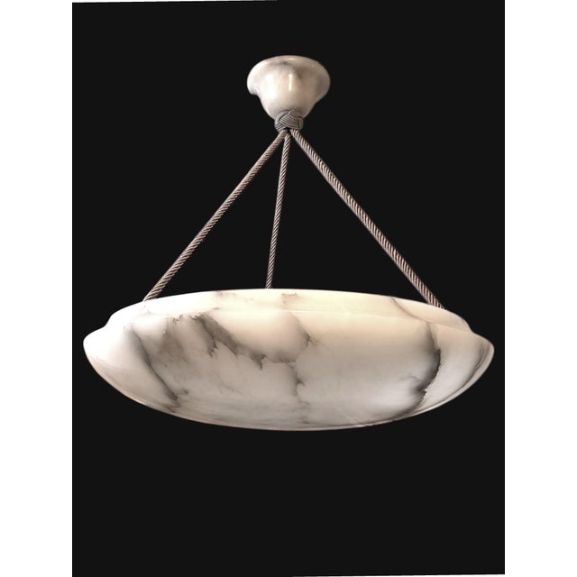 This alabaster chandelier with a modern, clean bowl silhouette works beautifully in both contemporary and classic...