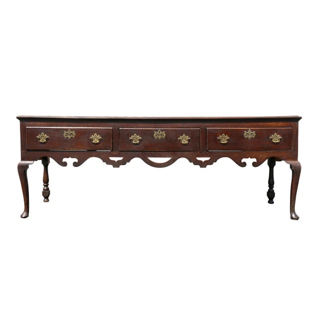 Rectangular top dresser base credenza over three drawers and a carved open work apron, raised on cabriole legs. Rear legs...