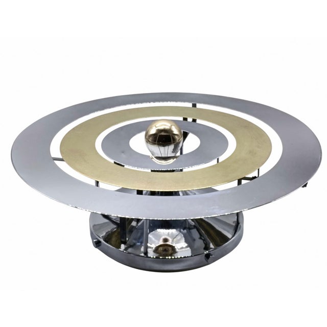 Unique Spage Age wall lamp from the 1970s, circular in shape, made of polished chrome-plated metal and brass. European...