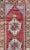 This vintage Turkish runner, hand-knotted from high-quality wool, features a warm color palette that includes faded soft...