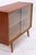 Vintage chest of drawers with delicate glass sliding doors and a slim base. The combination of open storage space and a...