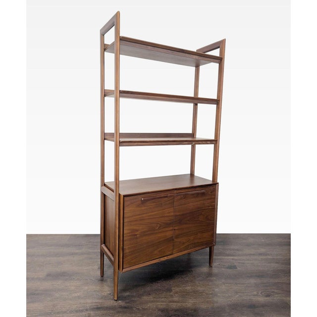 This Crate & Barrel bookshelf features a clean modern design with a rich walnut finish. It offers three open shelves for...