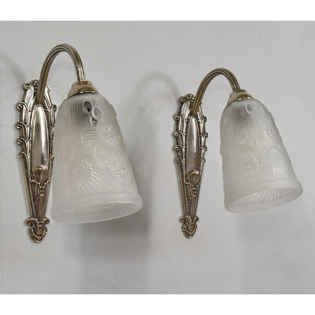 Marcel Hudry & Lorrain Daum A pair of French art deco floral motif Art Deco wall sconces made circa 1925-1935 in nickel-...
