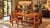 A rectangular table and four matching chairs in solid wood, likely sheesham (indian rosewood) or acacia, with warm...