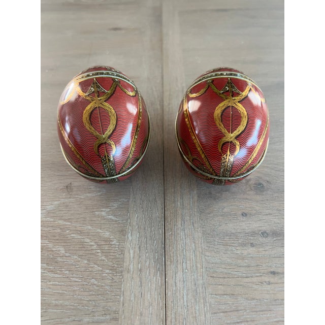 Two neoclassical style tin lithograph eggs.