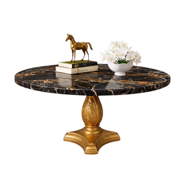 Description Striking Hollywood Regency–style pedestal table featuring a dramatic round black marble top with bold white...
