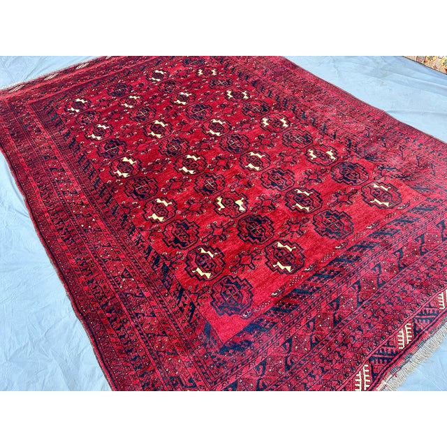 This classic Tekke Bokhara rug features rows of repeating octagonal "elephant's foot" guls in deep navy and ivory,...