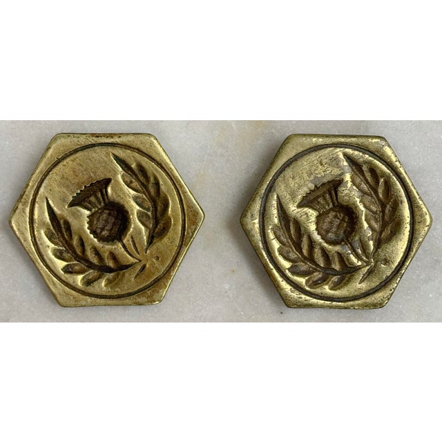 Vintage heavy brass molds with featuring pronounced pineapple and wreath relief. Hooks on reverse for hanging. Age wear....