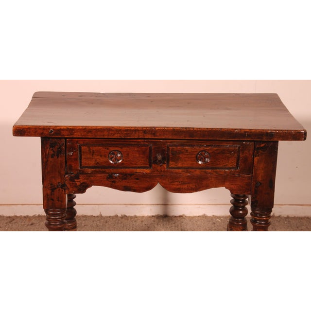 Superb 17th-century Spanish Renaissance walnut table, known as a "tosinera," with a central drawer. A small table of...